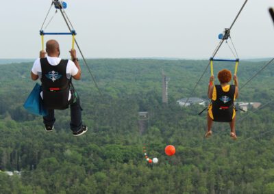 Couple flying side by side on HighFlyer Zipline at Foxwoods Resort Casino, Connecticut