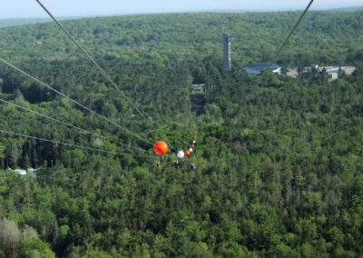 HighFlyer Zipline rider in flight on HighFlyer Zipline at Foxwoods Resort Casino, Connecticut