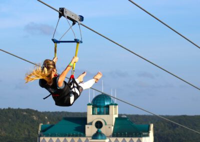 Woman riding solo on HighFlyer Zipline at Foxwoods Resort Casino, Connecticut