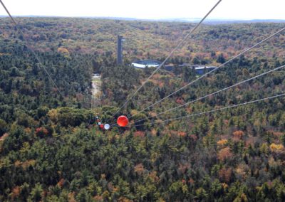 HighFlyer Zipline rider just launched with view to landing on a fall day at Foxwoods Resort Casino, Connecticut
