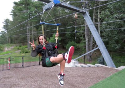 HighFlyer Zipline rider landing with peace sign at Foxwoods Resort Casino, Connecticut
