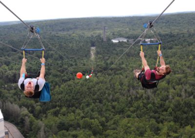 HighFlyer Zipline rider looking back at takeoff from Fox Tower rooftop, Foxwoods Resort Connecticut
